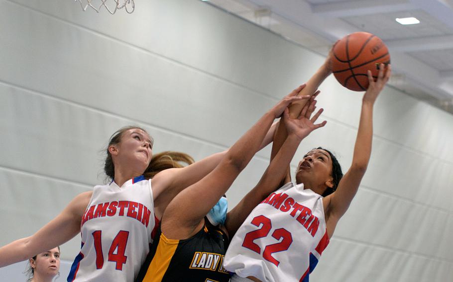 Ramstein’s Aliyah Jones, right, pulls down a rebound in front of her teammate Spice Harris and Stuttgart’s Alexis Thompson in a game on the first day of action at the DODEA-Europe Division I championships in Ramstein, Germany, Feb. 23, 2022. Stuttgart won 32-20.