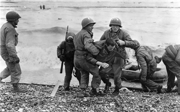 Omaha Beach, Normandy, France, June 6, 1944: Medics from the U.S. 5th and 6th Engineer Special Brigade (ESB) help wounded soldiers on Omaha beach, Fox Green and Easy Red sectors. Survivors of sunken landing craft who reached the beach by using a life raft are recovered by other troops.

Read the story of one of the many heroic medics, Bob Molinari, from Los Angeles, Calif, as written by Stars and Stripes reporter Bud Hutton, first published in Stars and Stripes' London edition, June 12, 1944 here.

META TAGS: DDAY80; WWII; World War II; D-Day; Operation Overlord; Battle of Normandy; military medical; beach; wounded; servicemember; WIA; casualty