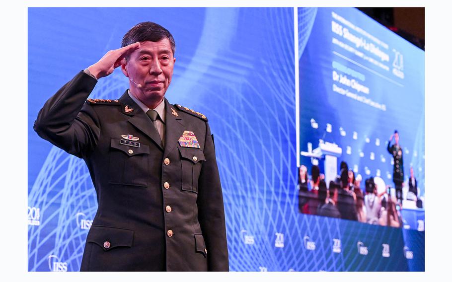 China's Minister of National Defence Li Shangfu salutes the audience before delivering a speech during the 20th Shangri-La Dialogue summit in Singapore on June 4, 2023. He has been replaced by navy veteran Dong Jun. 