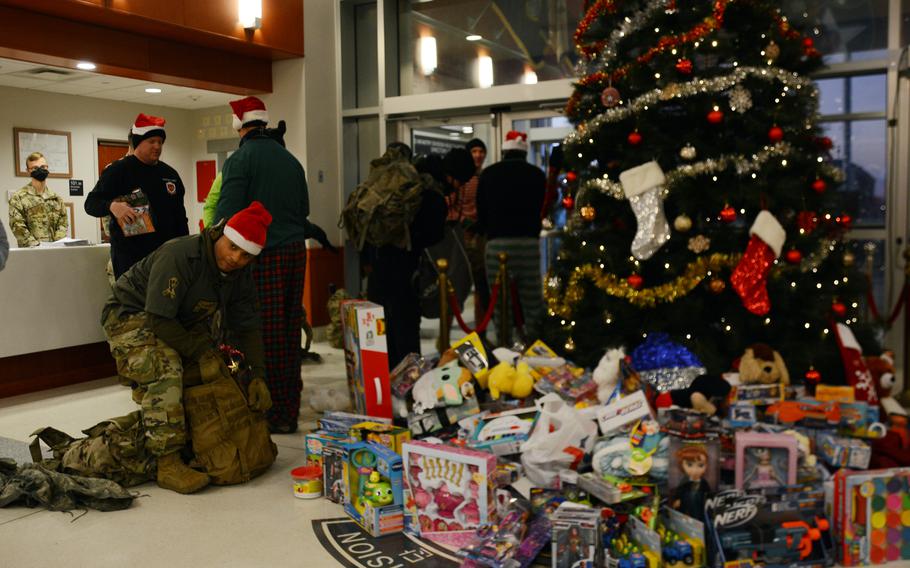 Soldiers unload rucksacks filled with toys and other gifts at 2nd Infantry Division headquarters, Camp Humphreys, South Korea, Thursday, Dec. 2, 2021. The presents will be donated to South Korean orphans for Christmas. 