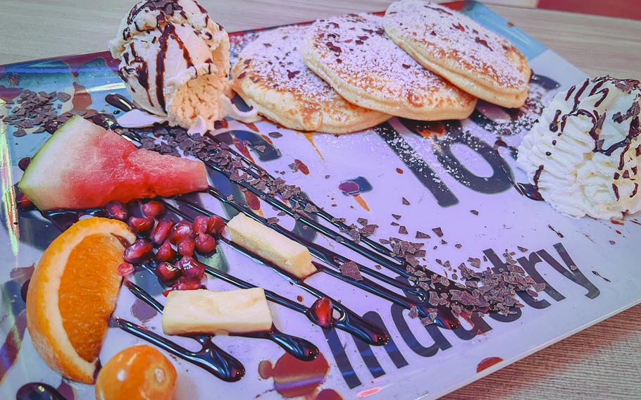 A stack of pancakes topped with vanilla ice cream and fresh fruit is served at Freeway Restaurant in Ruesselsheim, Germany, on  Nov. 7, 2023. The German version was fluffy and light.