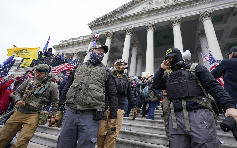 Members of the Oath Keepers extremist group stand on the East Front of the U.S. Capitol on Jan. 6, 2021, in Washington. 
