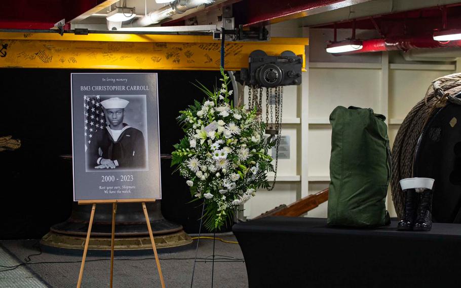 Sailors aboard the aircraft carrier USS Theodore Roosevelt gather Feb. 15, 2023, to mourn the death of Petty Officer 3rd Class Christopher Carroll.