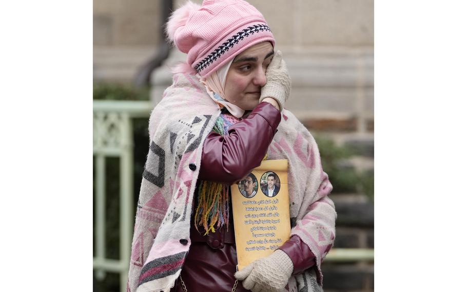 Yasemine, who lost her father and brother in Syria, reacts in front of the court in Koblenz, Germany, on Thursday, Jan. 13, 2022., after a German court convicted a former Syrian secret police officer of crimes against humanity for overseeing the abuse of detainees at a jail near Damascus a decade ago.