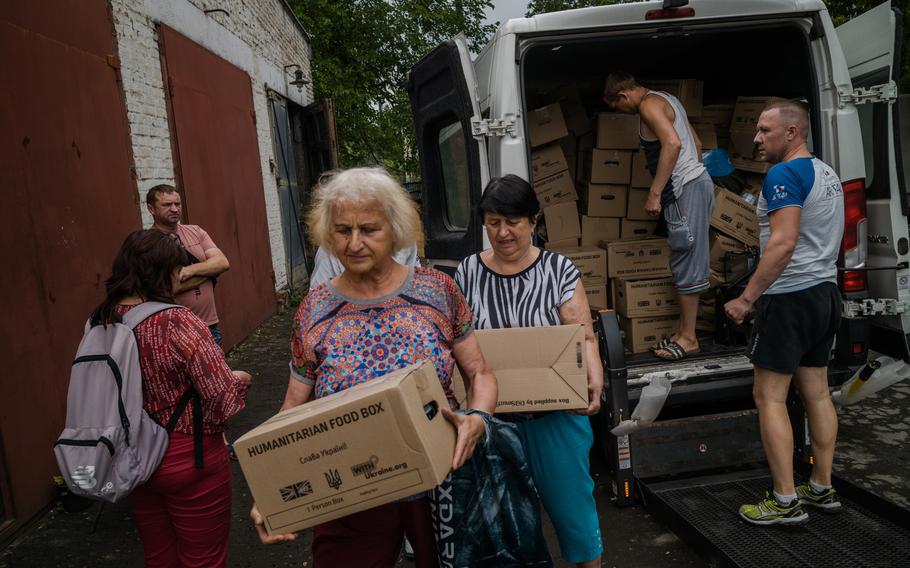 A humanitarian aid warehouse organized by Mykola Khanatov in Novomoskovsk, Ukraine, helps former Popasna residents. 
