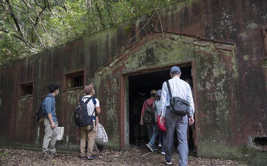 Japanese visitors tour a World War II-era munitions storage site at Tama Hills Recreation Area in western Tokyo, Wednesday, May 26, 2021. 