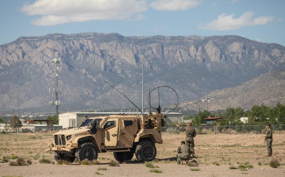 Marines set up a high frequency radio on Kirtland Air Force Base, N.M., May 11, 2021. Marines in tactical vehicles and trucks drove from Camp Lejeune, N.C., to Twentynine Palms, Calif., in one of the longest convoys in Marine Corps history.