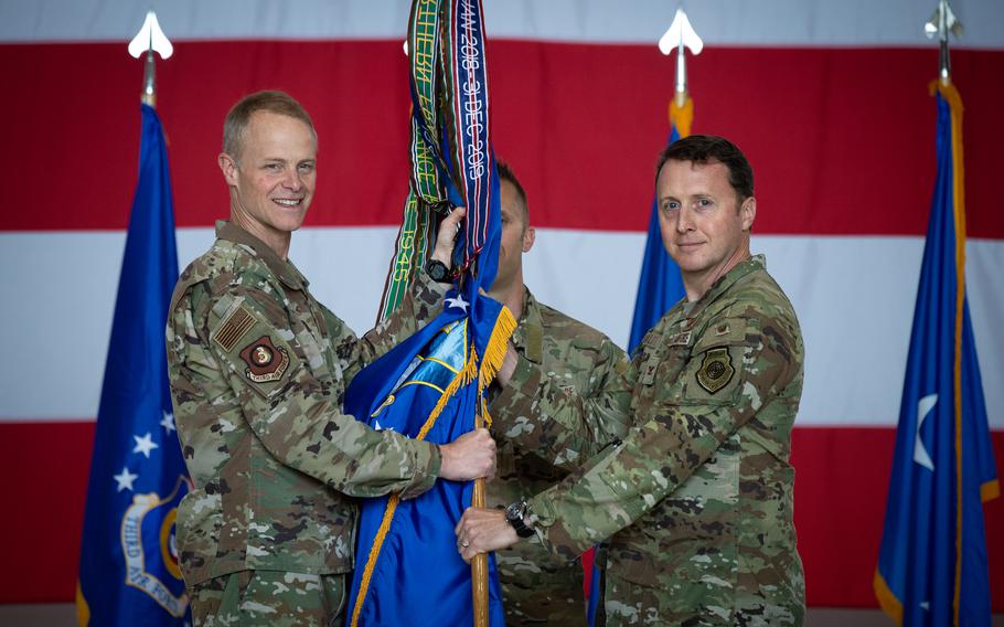 Col. Matthew Bartlett, right, accepts the ceremonial guidon and command of the 435th Air Ground Operations Wing from Maj. Gen. Derek France at a unit activation ceremony June 9, 2023, at Ramstein Air Base, Germany. The wing's airmen build expeditionary airfields and enable multi-theater support in Europe and Africa.