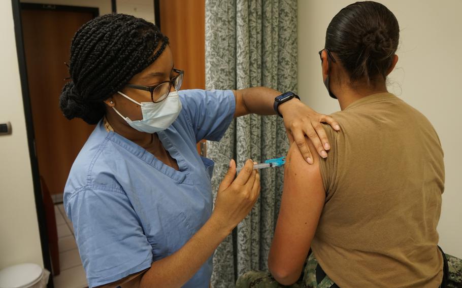 Seaman Dayshia Hall vaccinates a sailor at Naval Air Station Sigonella, Italy, Aug. 30, 2021. U.S. naval bases in Italy, Spain and Greece are urging their communities to continue to wear masks, maintain social distancing and limit their contacts while traveling, as COVID-19 case numbers continue to remain high.