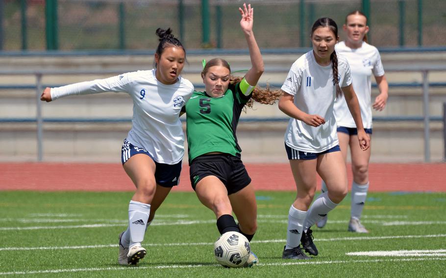 Black Forest Academy’s Esther Lee defends against Naples’ Emma Heavey, as Olivia Wilson watches, in the girls Division II final at the DODEA-Europe soccer championships in Ramstein, Germany, May 22, 2025. The Wildcat beat BFA 3-0.