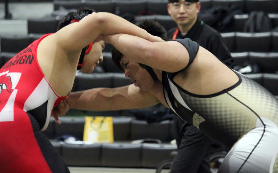 Humphreys' Dominic Meno, right, beat Seoul Foreign's Woochan Kim by technical fall at 215 pounds during Wednesday's Korea wrestling dual meet. The Blackhawks routed the Crusaders 57-4.