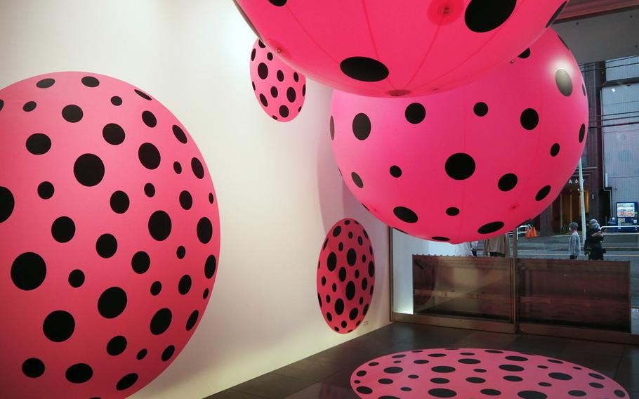 Upon entering the Yayoi Kusama Museum in Tokyo, you will encounter "Dots Obsession," a cluster of bright pink inflated balls with black polka dots.