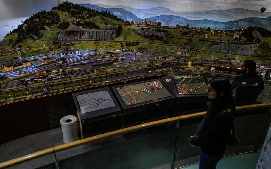 An employee at the Deutsche Bahn Museum in Nuremberg, Germany, operates a model train setup Dec. 20, 2023. This exhibit uses miniatures to demonstrate real-world train logistics.