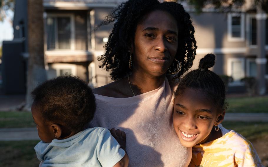 Kiara Age and her children, Kaiden Jones, 8, and Kobe Jones, 1, outside their home in Las Vegas. 