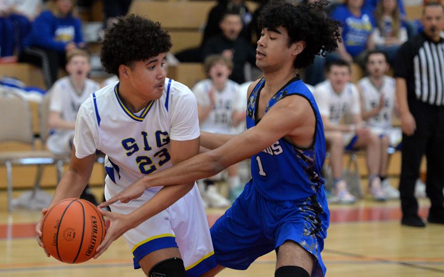 Brussels’ Jabriel Wells defends against Sigonella’s Drake Dawson in a Division III game at the DODEA-Europe basketball championships in Baumholder, Germany, Feb. 16, 2023. Sigonella won 38-12.