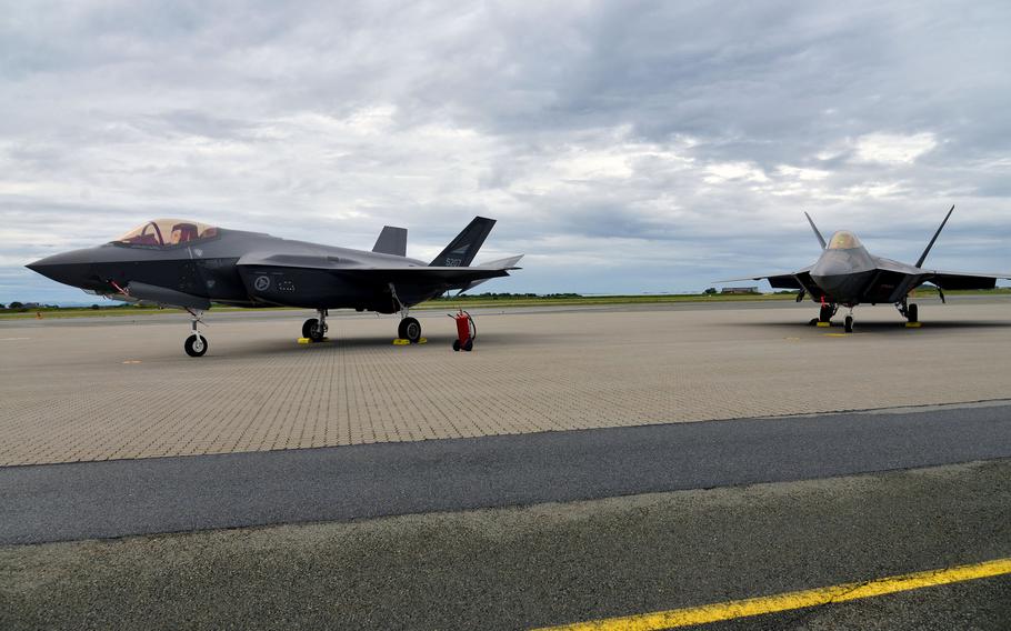 A Norwegian F-35 and a U.S. Air Force F-22 Raptor stand on the tarmac after landing at Orland Main Air Station, Norway in 2018. A 3,000-year-old Bronze Age burial mound has been uncovered near the air base, where Americans and other allied forces train. 
