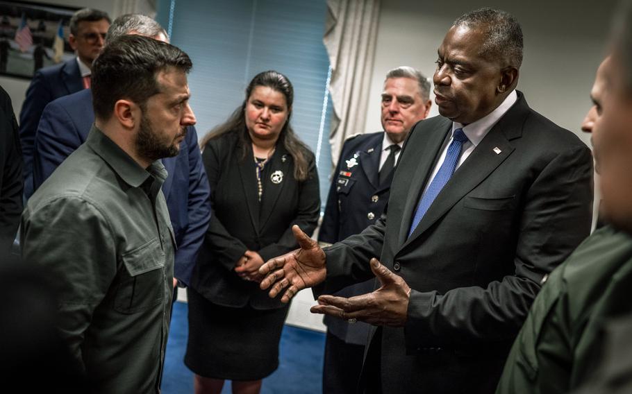 Defense Secretary Lloyd Austin speaks with Ukrainian President Volodymyr Zelenskyy during a visit to the Pentagon on Thursday, Sept. 21, 2023, as Army Gen. Mark Milley, the chairman of the Joint Chiefs of Staff, looks on.