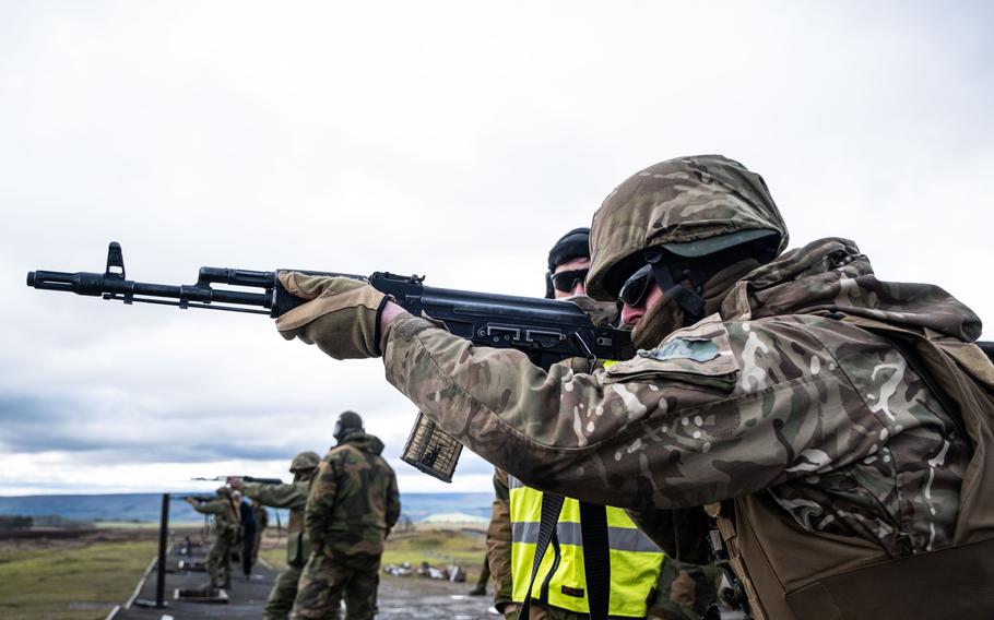 A Ukrainian soldier fires a rifle under the supervision of a Norwegian army instructor during training of Ukrainian recruits by NATO allies in the United Kingdom in March 2023. NATO this week will agree to a plan that will put the alliance in charge of efforts to arm and train the Ukrainian military, marking a shift away from an effort that so far has been an American-led endeavor. 