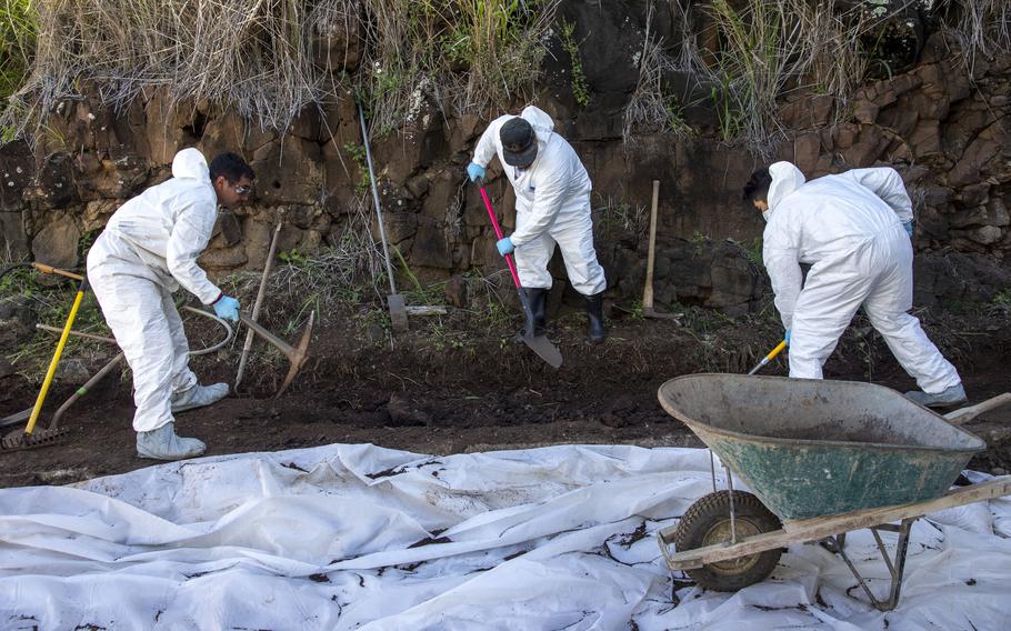 Workers move contaminated soil at the Red Hill Bulk Fuel Storage Facility in Halawa, Hawaii, on Dec. 1, 2022. 