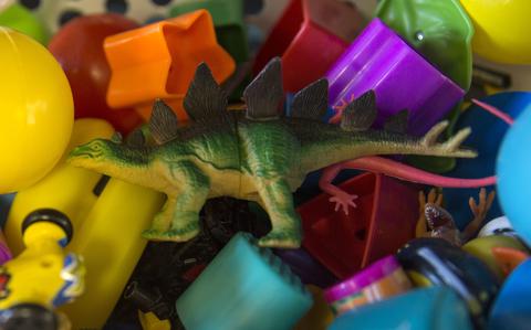 Toys sit in a basket.