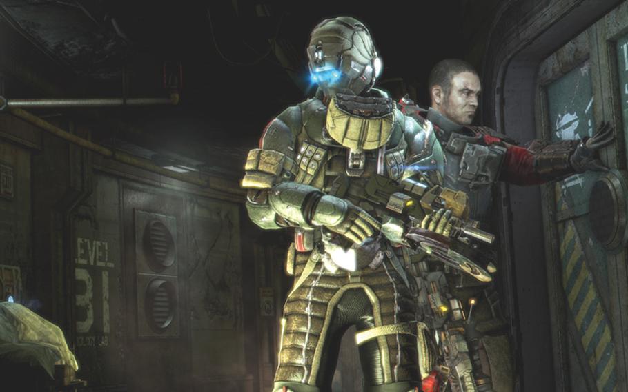 Isaac Clarke, left, and John Carver prepare to head into battle in the third installment of the ‘Dead Space’ series.