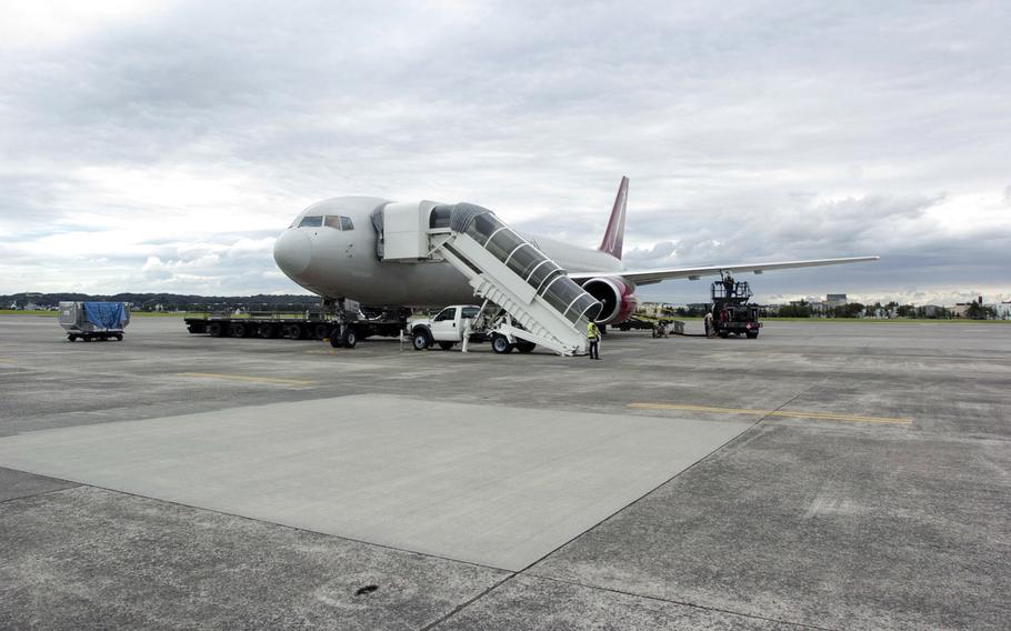 A passenger jet receives fuel and a cleaning prior to take off at Yokota Air Base, Japan, Sept. 26, 2013. Space-available travel can come with some discomfort -- waiting on the tarmac in hot or cold weather, for instance -- but with some planning and know-how, monetary rewards and unexpected adventures can more than make up for these inconveniences.