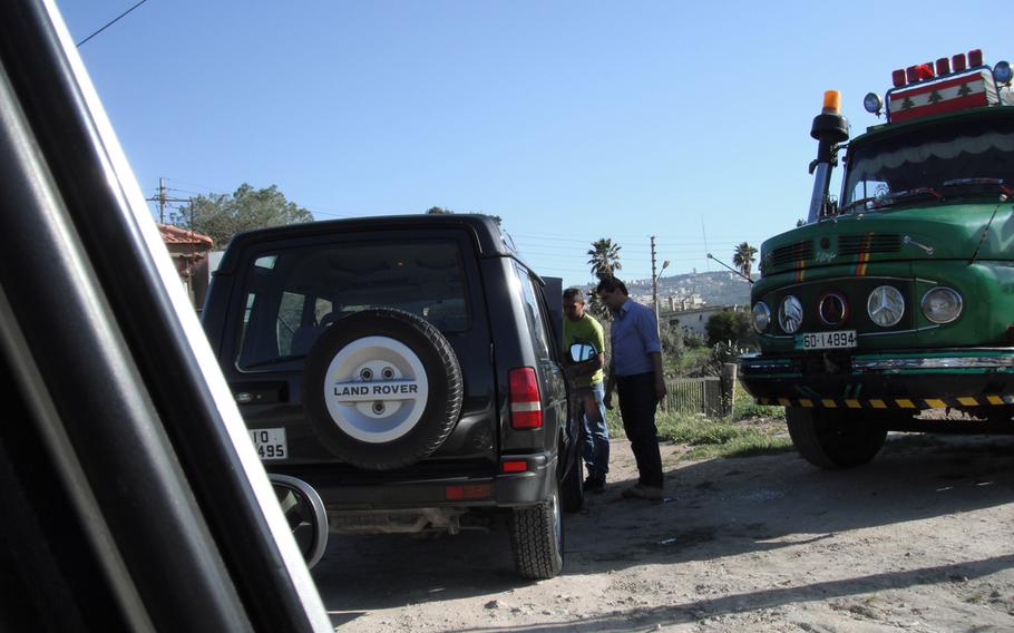 Mechanics pour water into Siobhan Fallon’s overheating radiator toward the end of her ill-fated outing in Jordan.