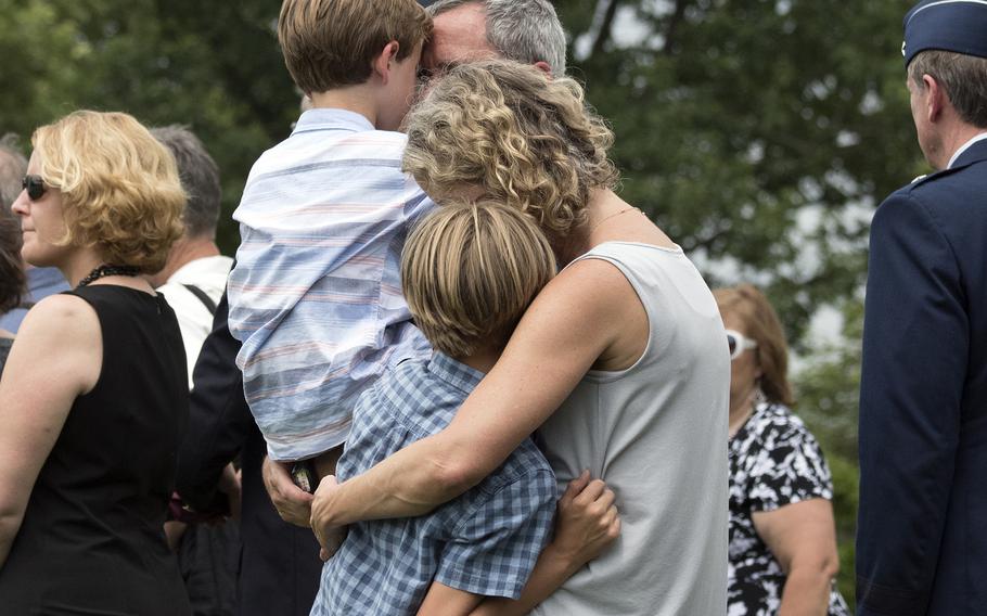 A family shares a quiet moment together during the funeral at Arlington National Cemetery on June 27, 2018, for five airmen that were killed during World War II.