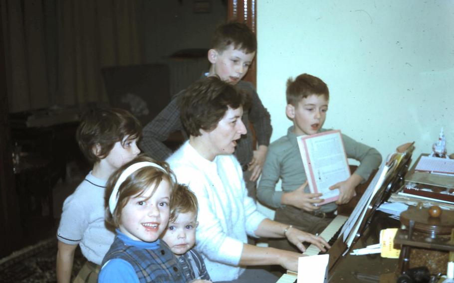 Mrs. Louise Bickford, playing piano with her children in the 1960s.