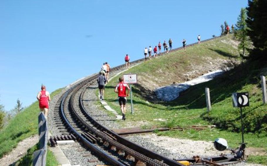 On May, 26, runners race against the Schafberg steam train, trying to beat its 45-minute journey time, in St. Wolfgang im Salzkammergut, Austria. 
