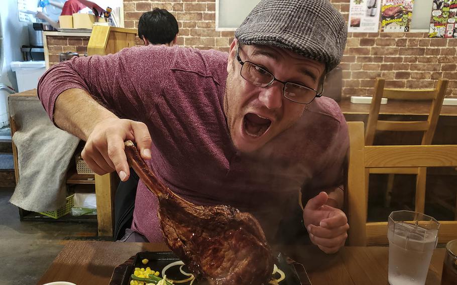 Reporter Theron Godbold takes a selfie before digging into his enormous Tomahawak steak from Monster Grill in Tokyo. 