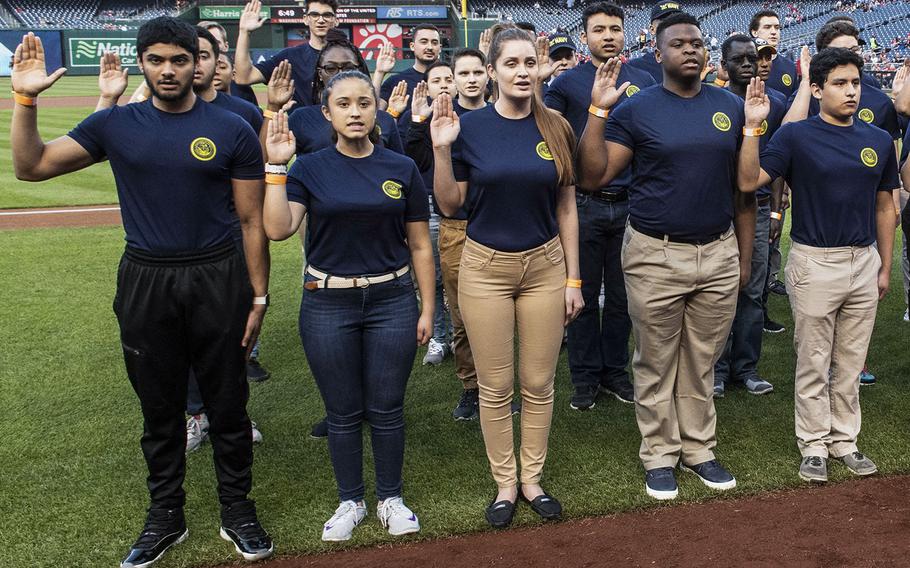 U.S. Navy recruits are sworn in during a ceremony before a Washington Nationals game in 2019.