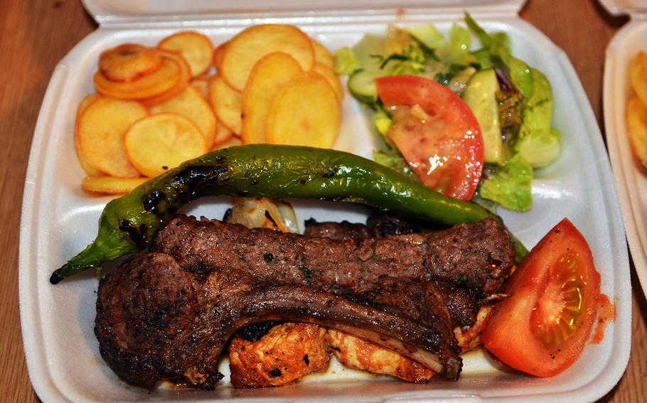 Grilled lamb with a roasted pepper, served with fried potatoes and a side salad, delivered from Chateau Kefraya, a Lebanese restaurant in Wiesbaden-Erbenheim, Germany.