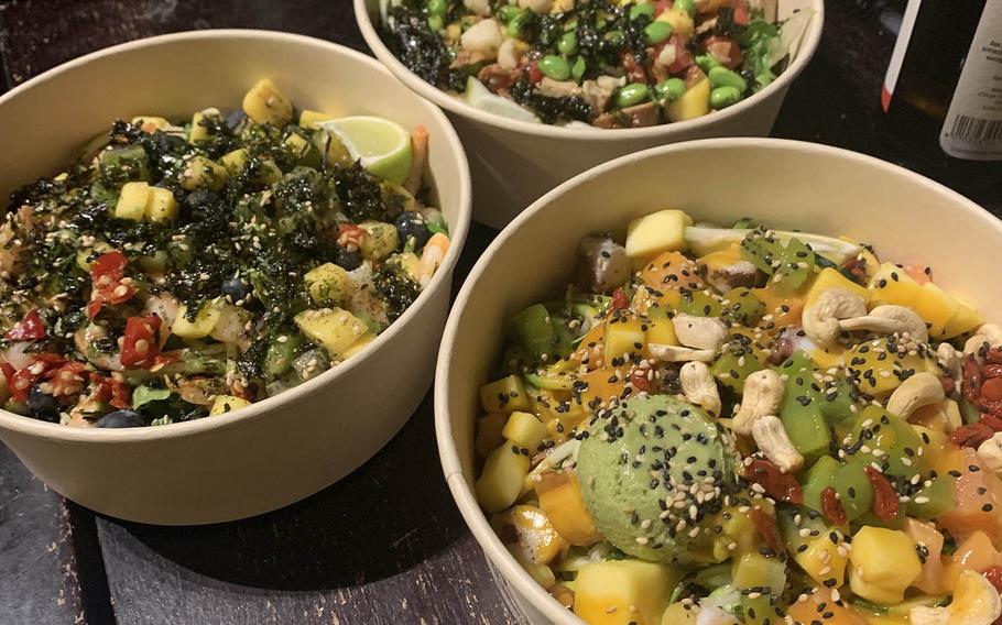 Sampling different poke bowls in Regensburg, Germany, that are full of toppings that you can customize to your liking.