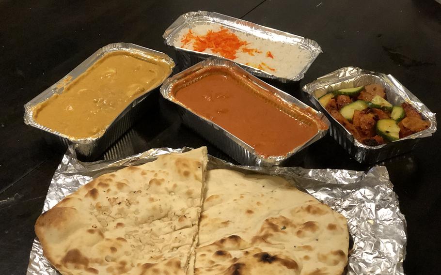 The meal from Bombay Restaurant includes lamb tikka appetizer, chicken tikka masala, chicken nurani and naan bread.