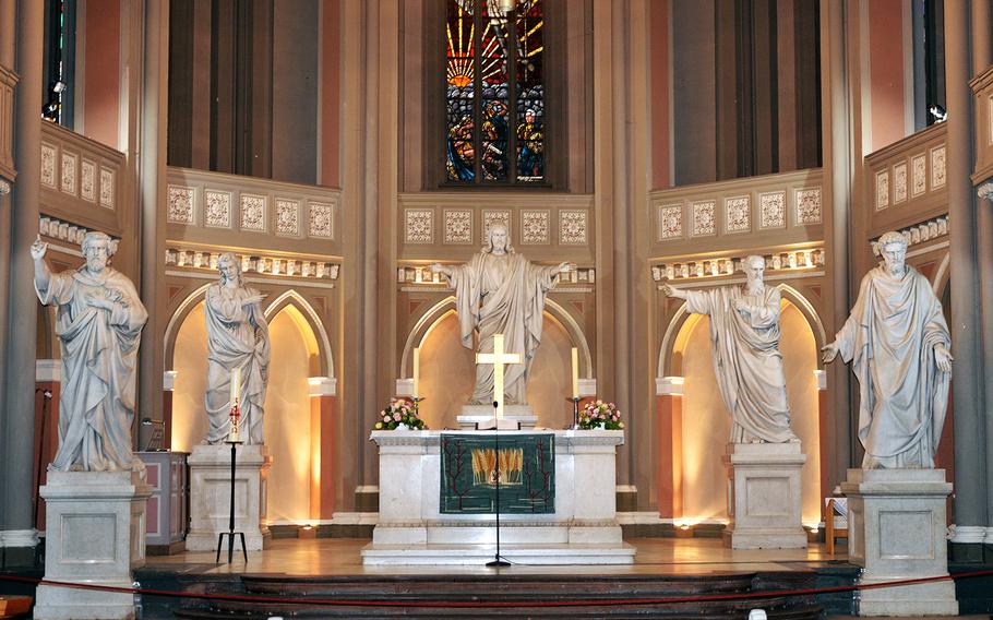 Statues of Jesus Christ and the four Evangelists, Matthew, Mark, Luke and John, who are said to have written four of the gospels in the New Testament of the Bible, overlook the altar in the Marktkirche in Wiesbaden, Germany.