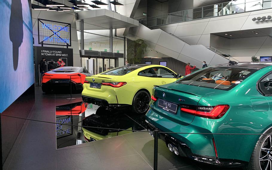 The main floor of the BMW Welt in Munich, Germany, Oct. 14, 2020, includes, the latest models of the BMW M4, center, and M3, right. 
