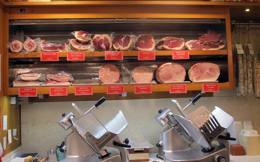 Among Il Ceppo's many offerings are cooked and cured hams, a variety of salami and other cured meats. The Vicenza store has done brisk takeout business during Italy's lockdown.  