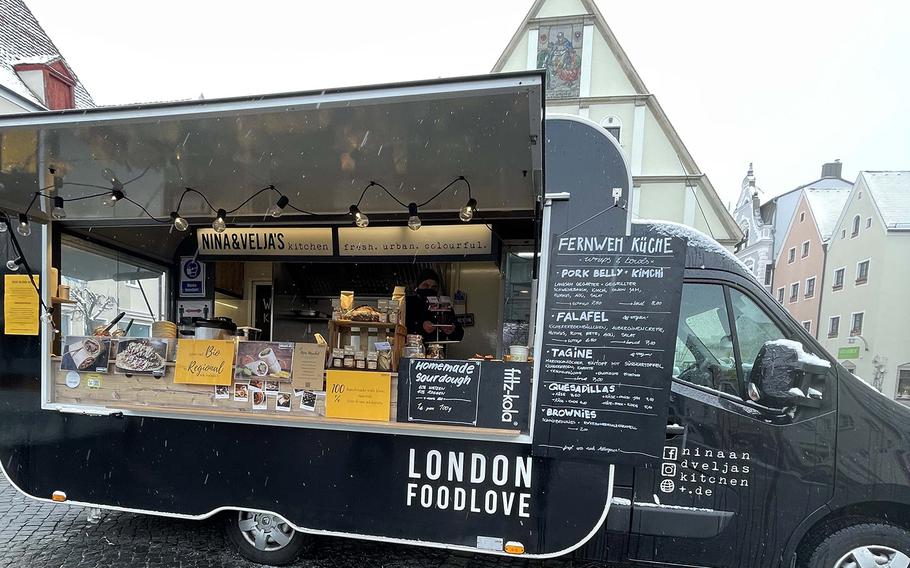 Nina & Velja's Kitchen food truck offers ''wanderlust cooking,'' including brownies, quesadillas and slow-cooked pork belly with kimchi, onion jam, hummus, aioli and salad, at the outdoor market in Weiden, Germany, April 7, 2021. 
