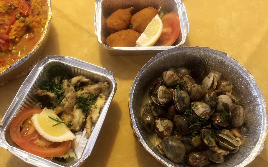 The three tapas we enjoyed from Casa Algarve in Griesheim were, clockwise from top, crabmeat croquettes, clams in white wine with garlic and fried anchovies. Rabbit paella is at top left.