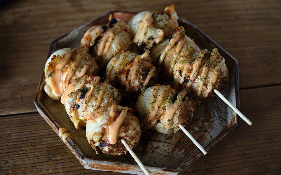 Takoyaki, or grilled octopus balls, are a popular street food in Japan made of deep-fried batter filled with chopped octopus. 