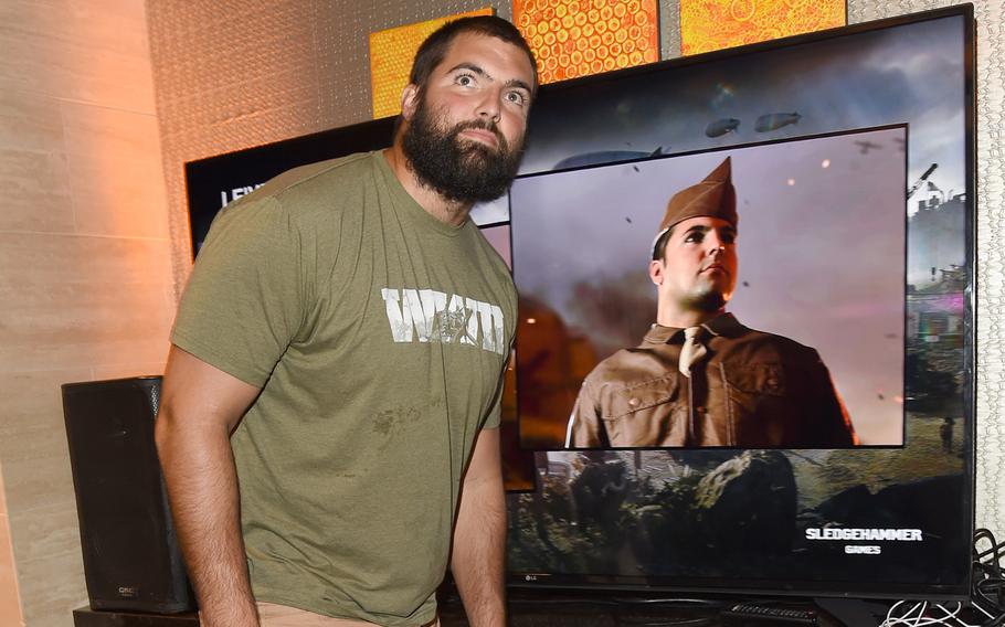 Alejandro Villanueva, former Army Ranger and current NFL star, is playing a role in this year's "Call of Duty: WWII."  Villanueva poses next to a model of his character in the game. 