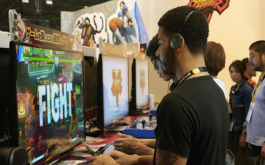 Visitors prepare to battle in Street Fighter V at the Tokyo Game Show 2015 in Chiba, Japan, on Friday, Sept. 17, 2015.