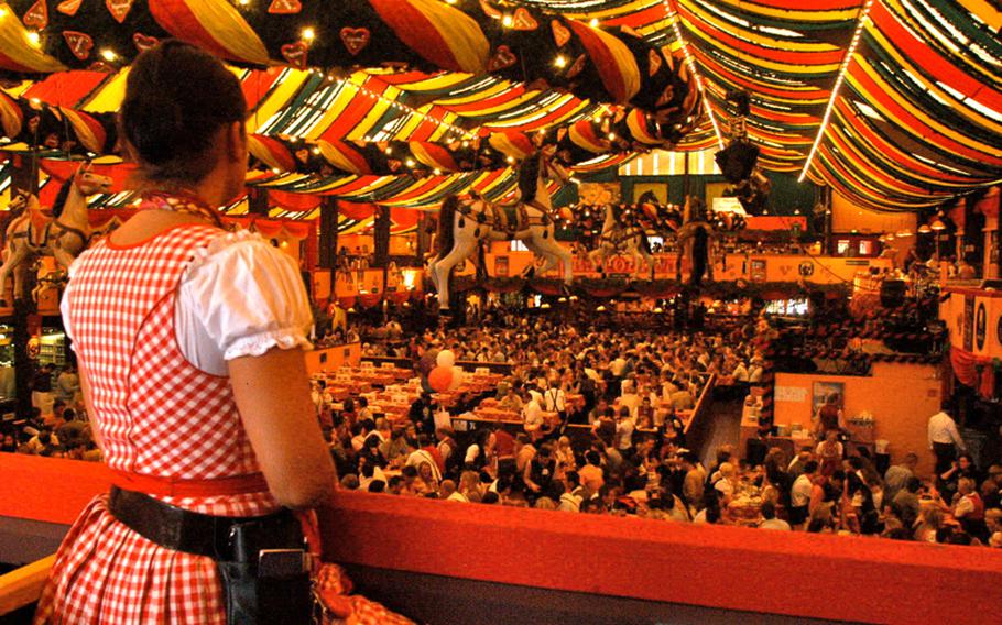 A server stares out at the Hippodrom hall as it begins to fill with thirsty revelers before the start of Oktoberfest.