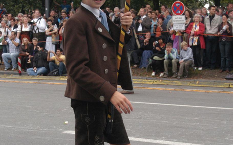 A boy wearing traditional Bavarian garb marches in the Grand Entry of Oktoberfest Landlords and Breweries, an annual parade to kick off the start of Oktoberfest.