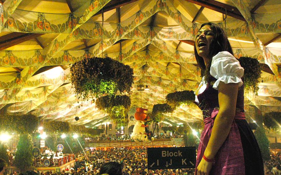 A woman sings with the oompah band at the Hofbrau tent.