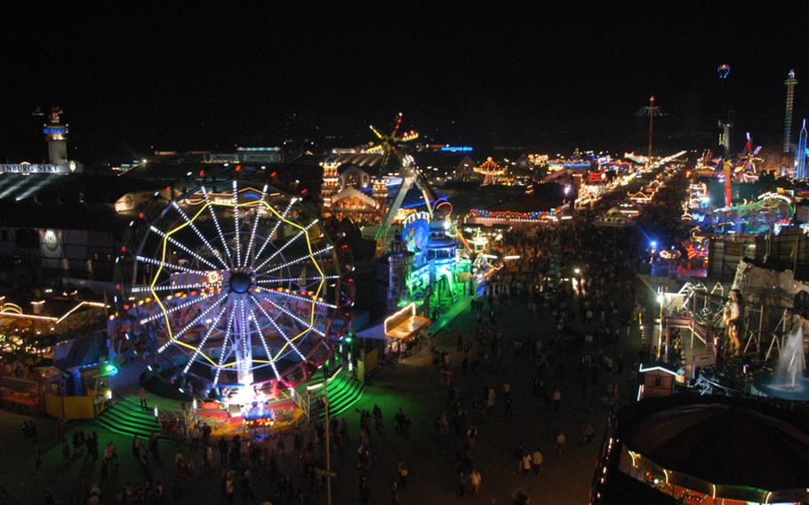 From atop the large Ferris wheel, the festival grounds glow with neon lights. Oktoberfest is more than a beer fest; it also has all the staples of a carnival.