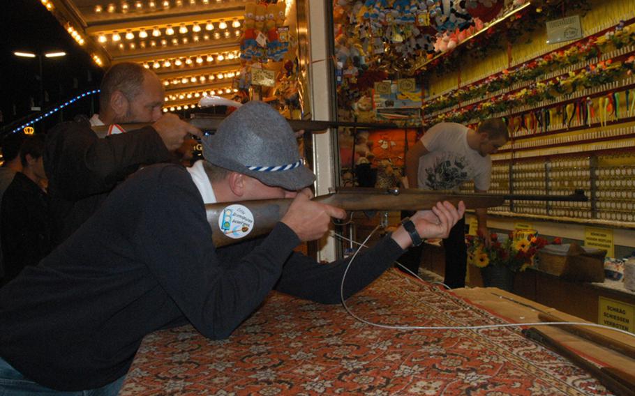 A man takes aim at one of the many games of skill and chance on the Oktoberfest midway.