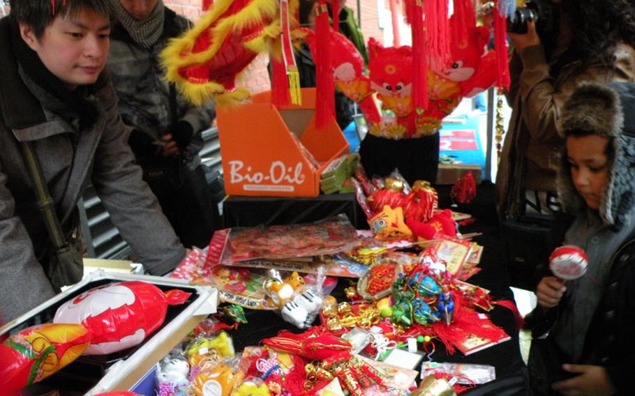 A street vendor sells various trinkets to people at the Chinese New Year festival in London marking the beginning of the Year of the Rabbit.