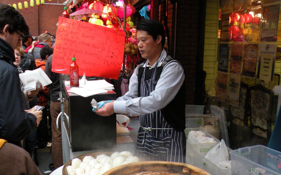 A Chinese street vendor sells traditional dim sum to passers-by at the 2011 Chinese New Year celebration in London on Feb. 6.